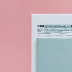 IRS Form 1040 with laptop and calculator used to pay federal taxes online easily from home