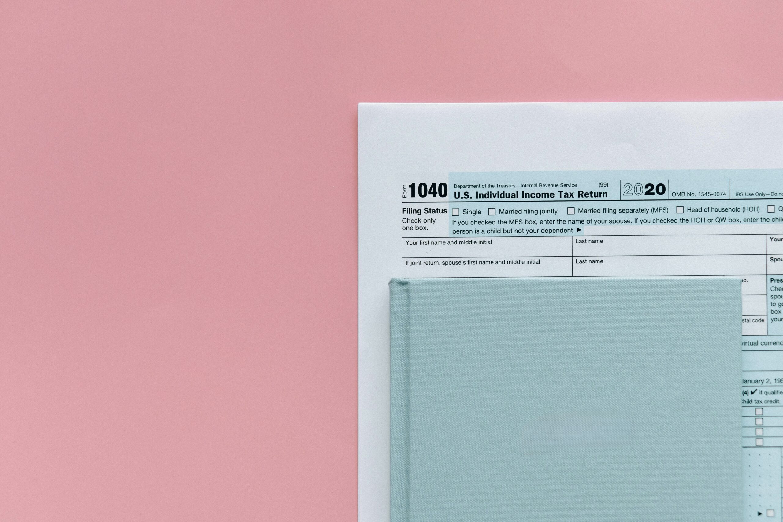 IRS Form 1040 with laptop and calculator used to pay federal taxes online easily from home