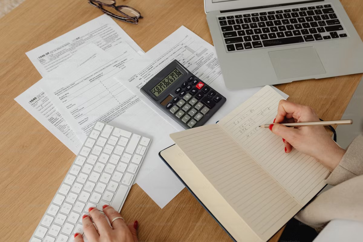 Home office scene illustrating Tax Deductions Every Freelancer Should Claim When Working from Home with laptop and documents