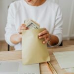 Colorful cash envelopes arranged on a table for the Cash Envelope Challenge, helping track expenses and improve money management.