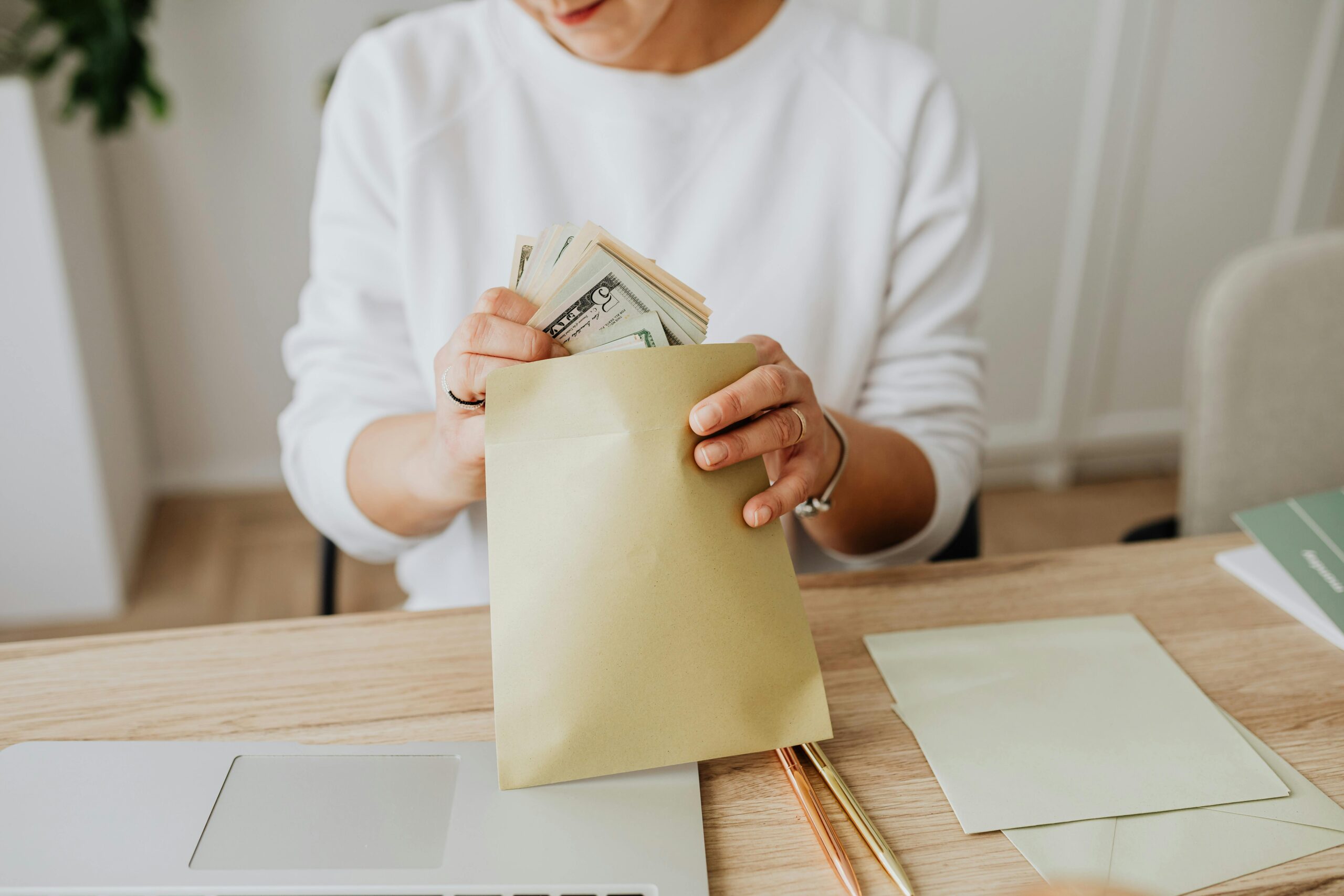 Colorful cash envelopes arranged on a table for the Cash Envelope Challenge, helping track expenses and improve money management.