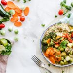 Colorful plate of High Protein Vegetarian Meals with beans, quinoa, and vegetables served on a rustic wooden table.