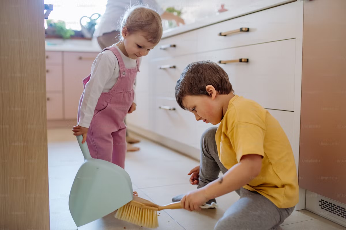 Parents using household chores to teach kids about money using chores and financial responsibility.